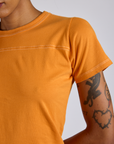 Jr. Varsity Tee in Creamsicle Orange close up on Kira
