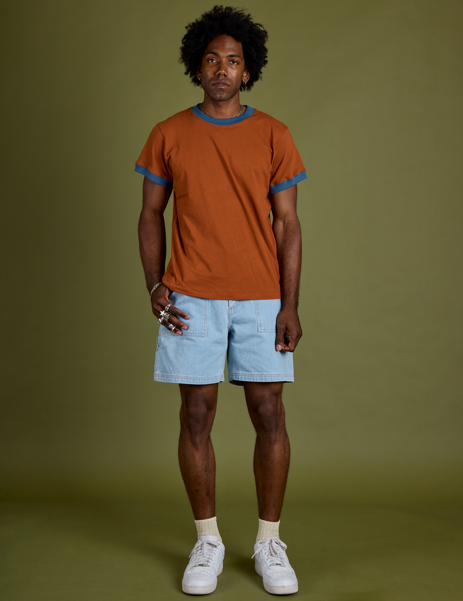 Jerrod is wearing Vintage Ringer Tee in Burnt Terracotta and light wash Carpenter Shorts