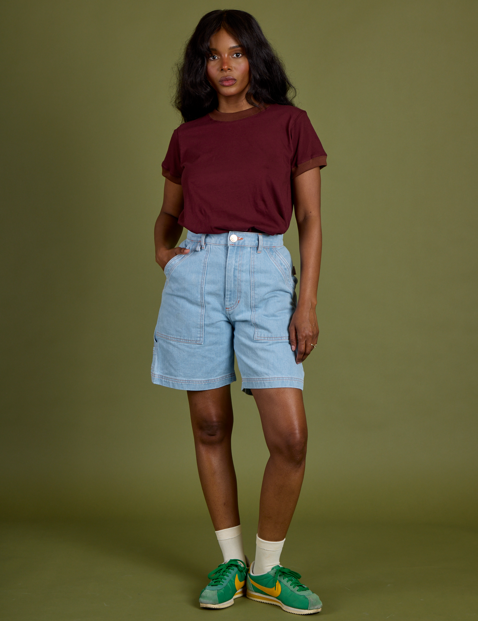 Kandia is wearing Vintage Ringer Tee in Red Wine tucked into light wash Carpenter Shorts 