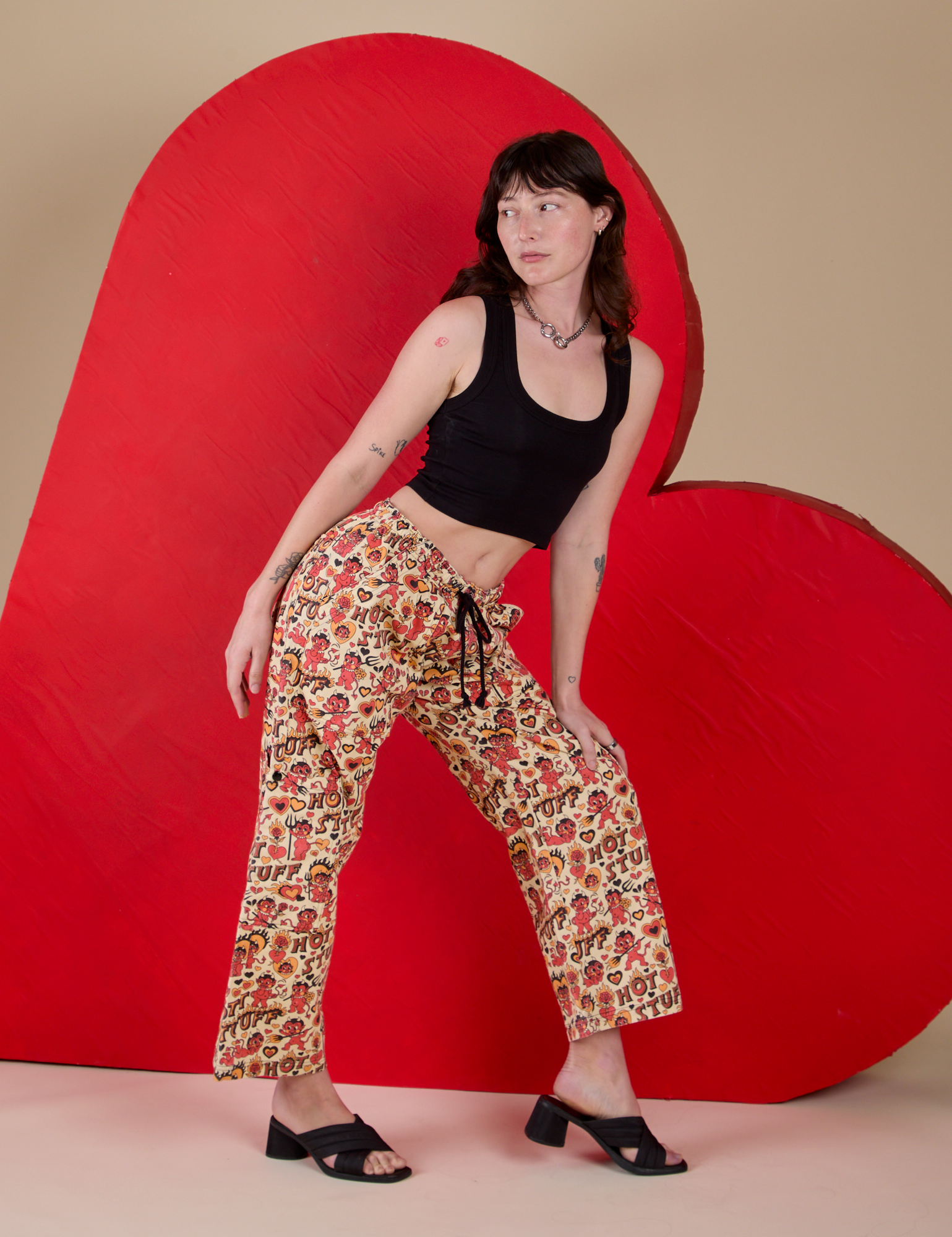 Side view of Hot Stuff Drop Pocket Cargo Pants and black Cropped Tank on Alex