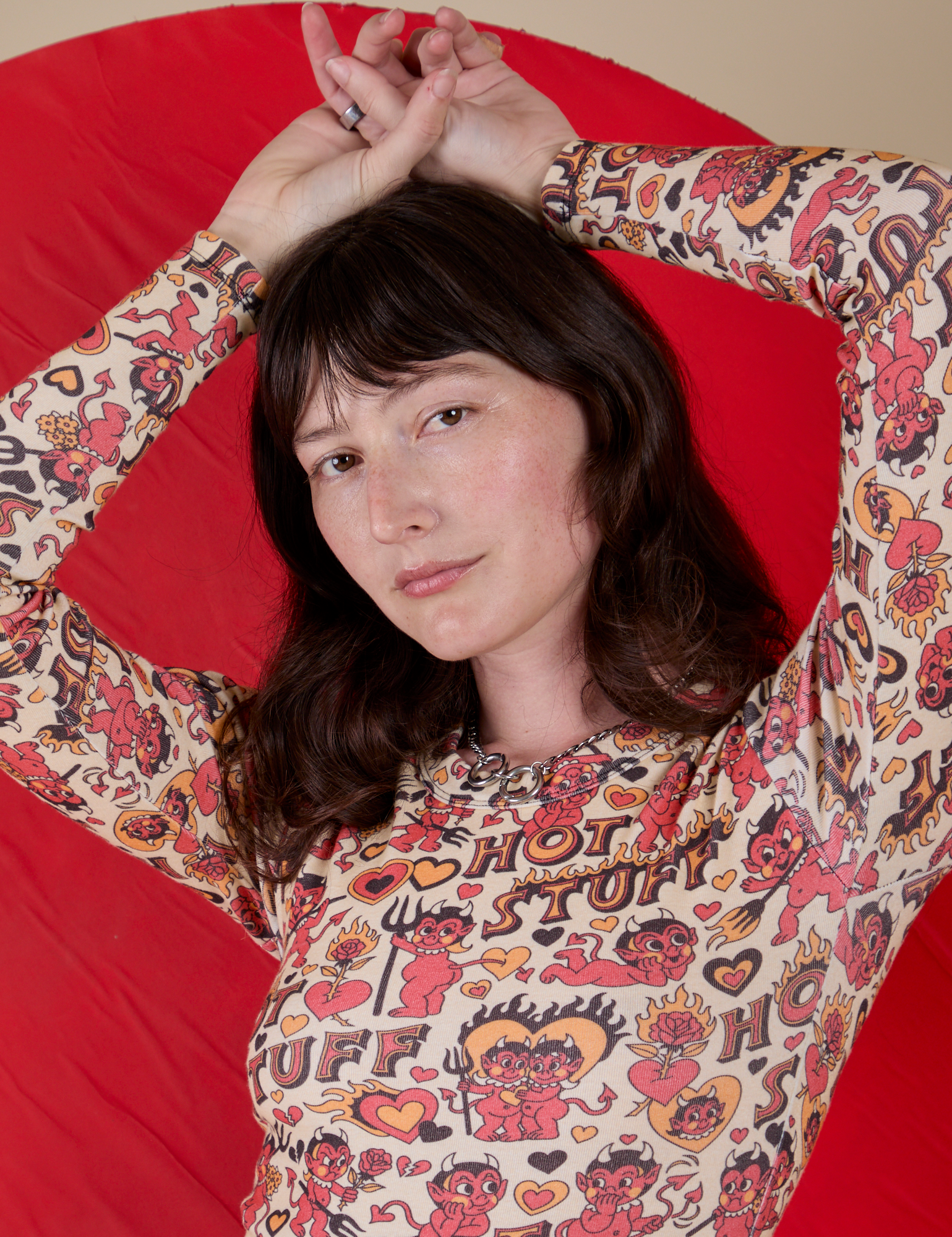 Long Sleeve Baby Tee in Hot Stuff Print front close up on Alex