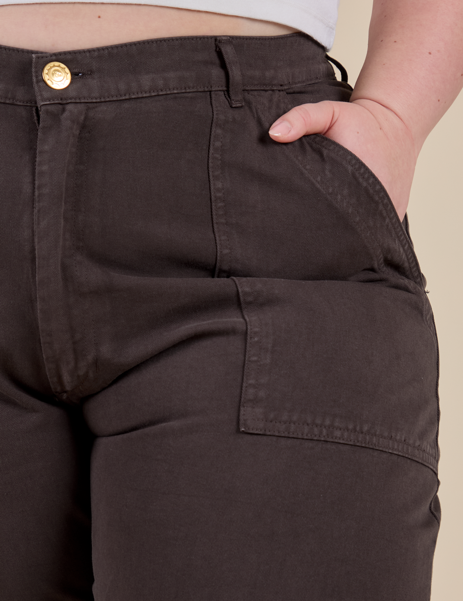 Close up of Ashley's hand in the front pocket of Work Pants in Espresso Brown