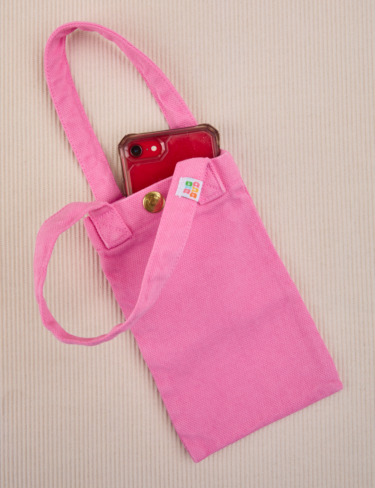 Phone tucked into bubblegum pink Cell Phone Tote