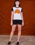 Alex is wearing Anniversary Tee in Smile paired with black Work Shorts