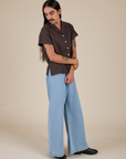 Side view of Pantry Button-Up in Espresso Brown and light wash Indigo Wide Leg Trousers on Anthony
