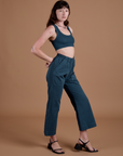 Side view of Action Pants in Lagoon and lagoon Mini Tank on Alex