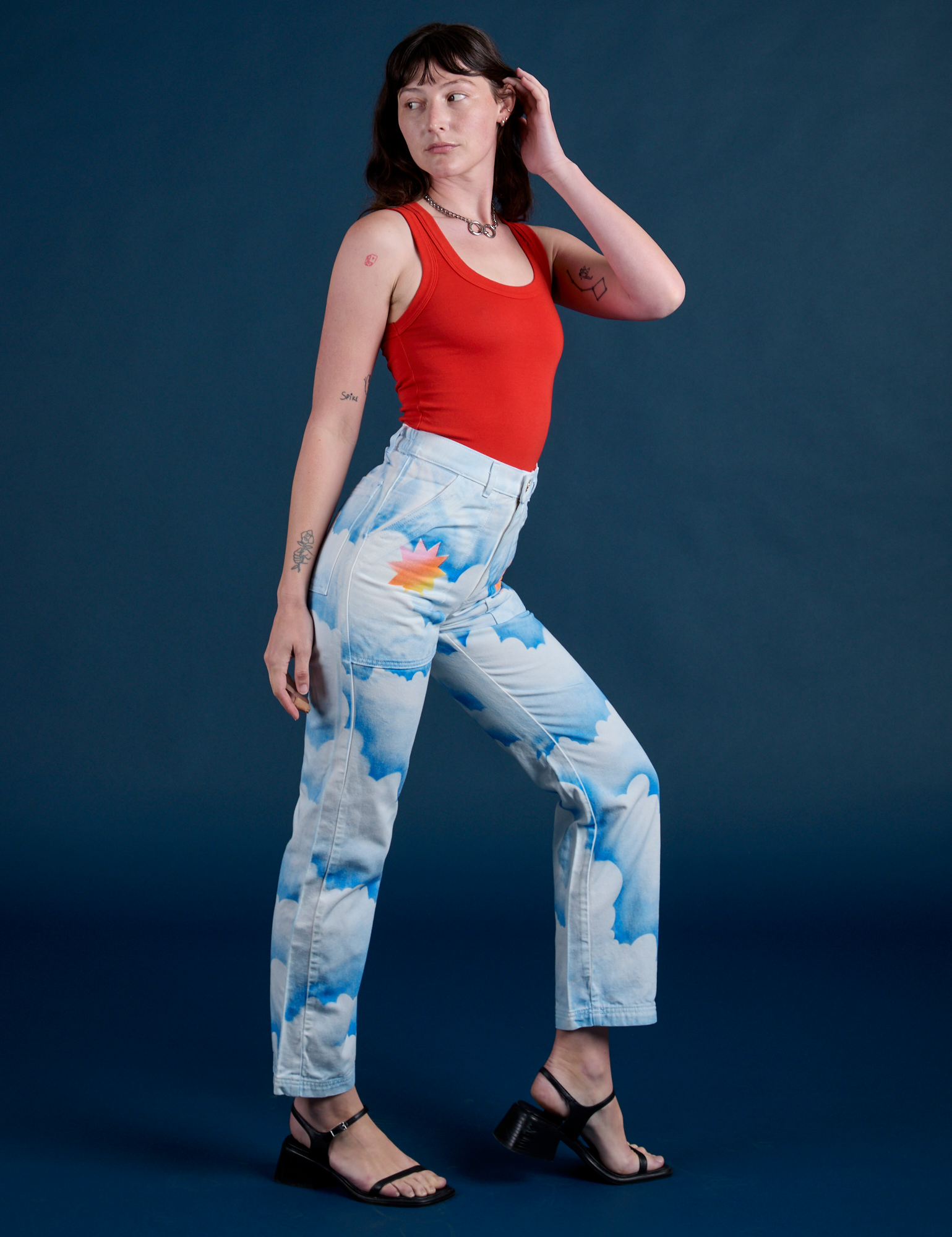 Side view of Work Pants in Sunny Cloud Airbrush and mustang red Tank Top on Alex