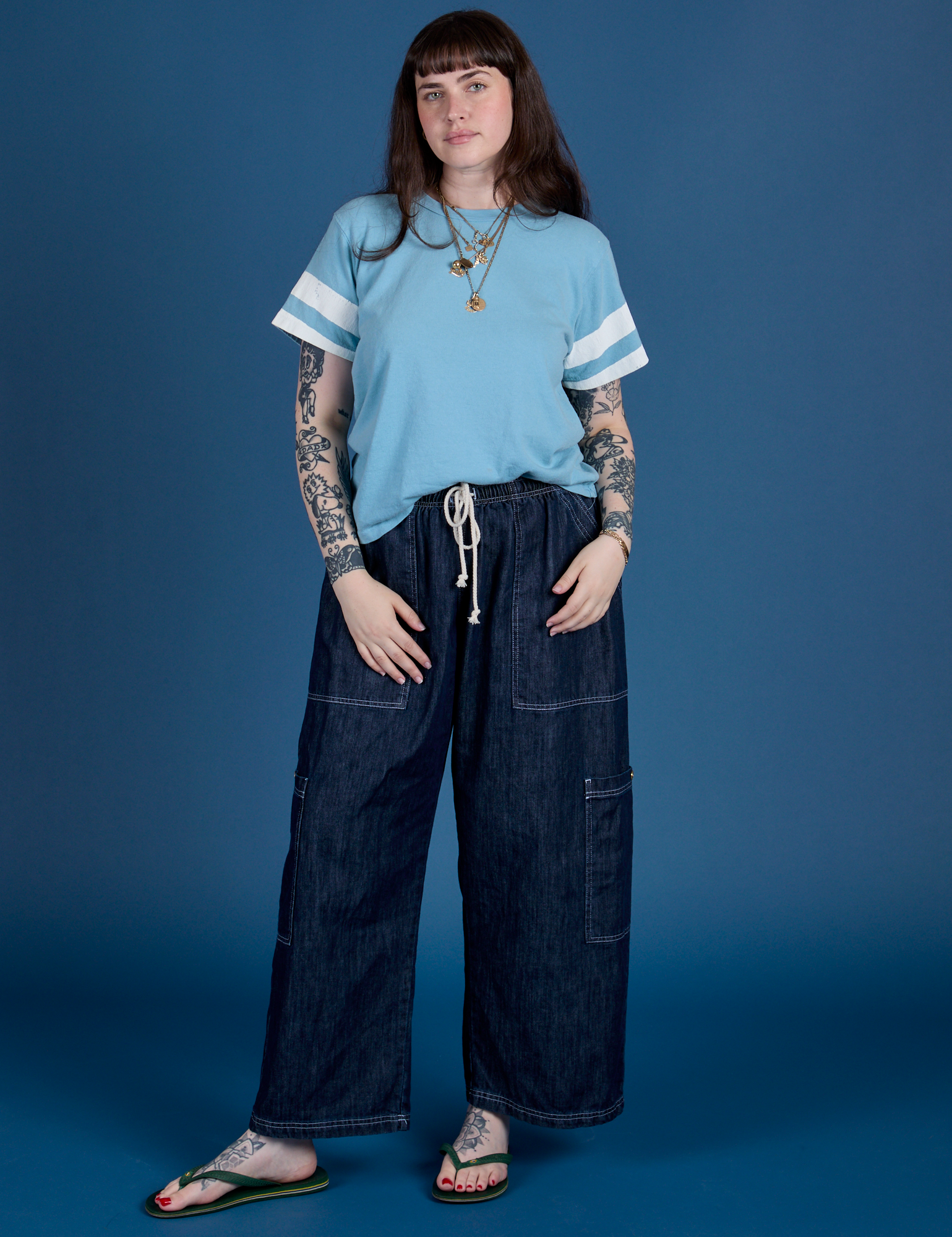 Sydney is wearing Painted Burly Tee in Baby Blue and denim Drop Pocket Cargo Pants