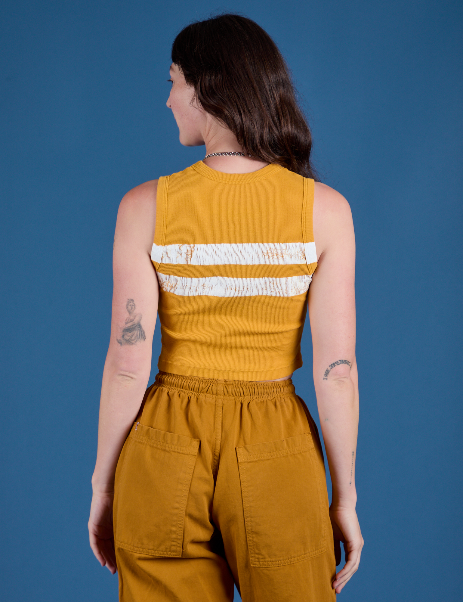 Painted Muscle Tee in Mustard Yellow back view on Alex