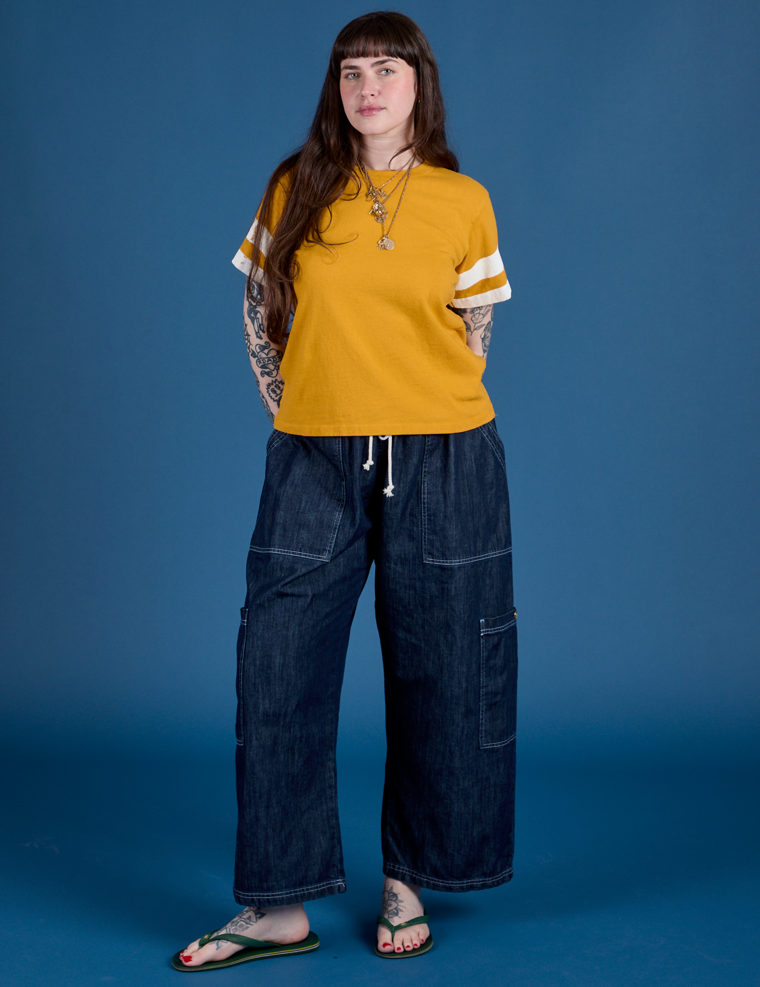 Sydney is wearing Painted Burly Tee in Mustard Yellow and denim Drop Pocket Cargo Pants