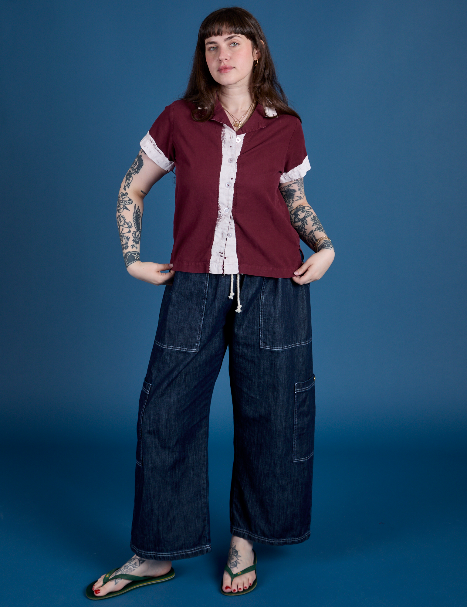 Sydney is wearing  Painted Pantry Button-Up in Red Wine and dark wash Drop Pocket Cargo Pants