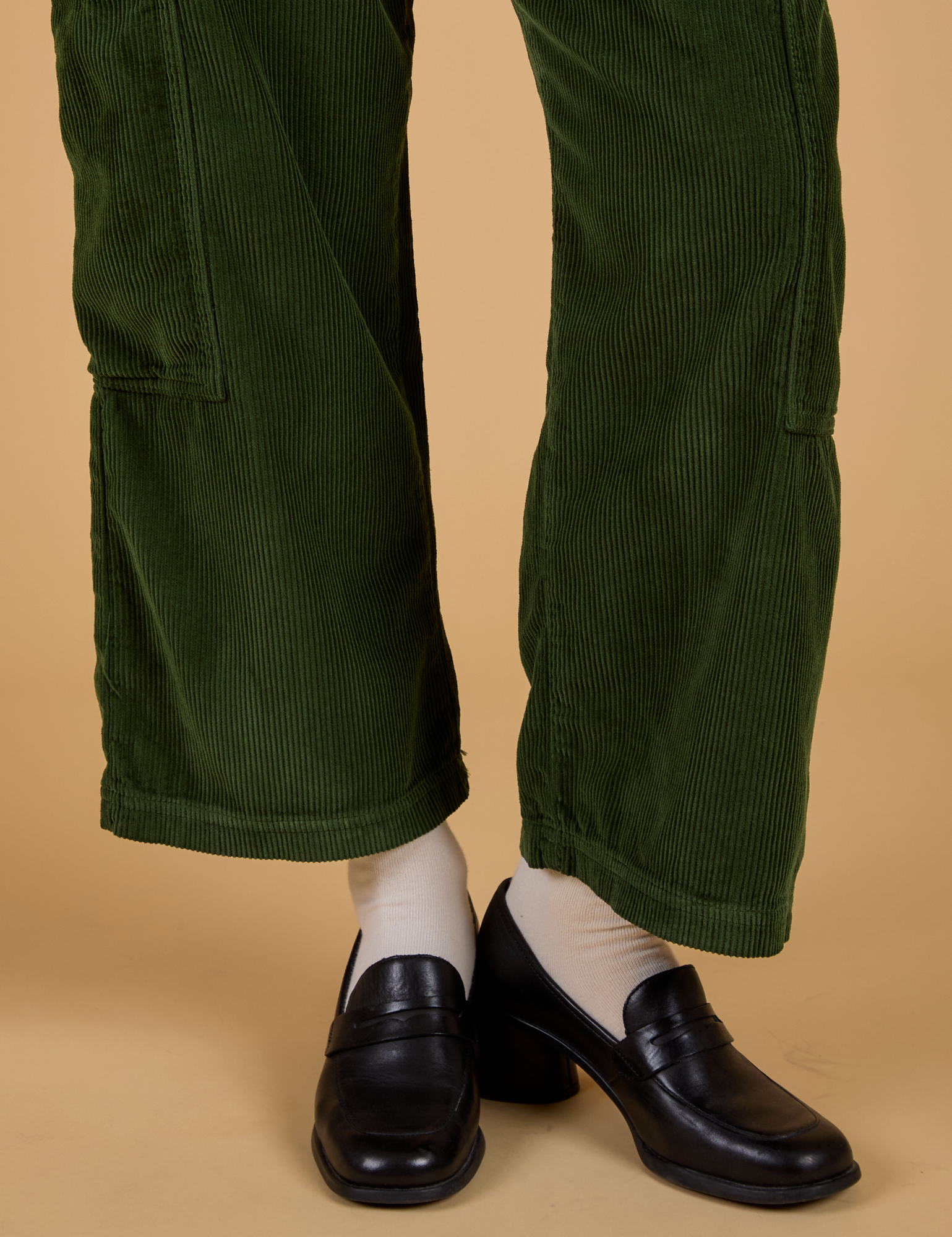 Corduroy Drop Pocket Cargo Pants in Evergreen pant leg close up on Alex