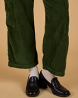 Corduroy Drop Pocket Cargo Pants in Evergreen pant leg close up on Alex