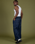Angled back view of Denim Drop Pocket Pants in Dark Wash and vintage tee white Cropped Tank on Isaac