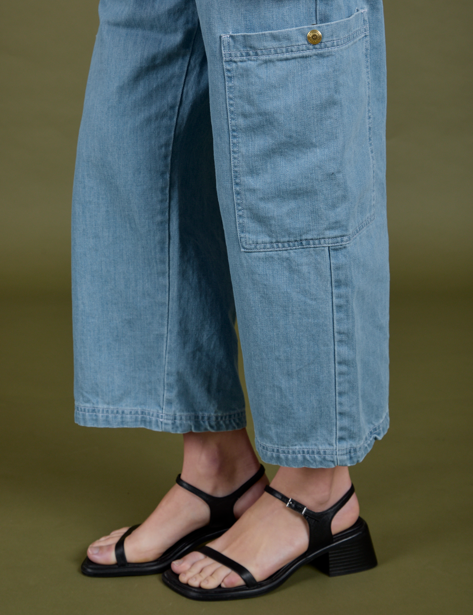 Close up of pant leg of Denim Drop Pocket Pants in Light Wash on Alex