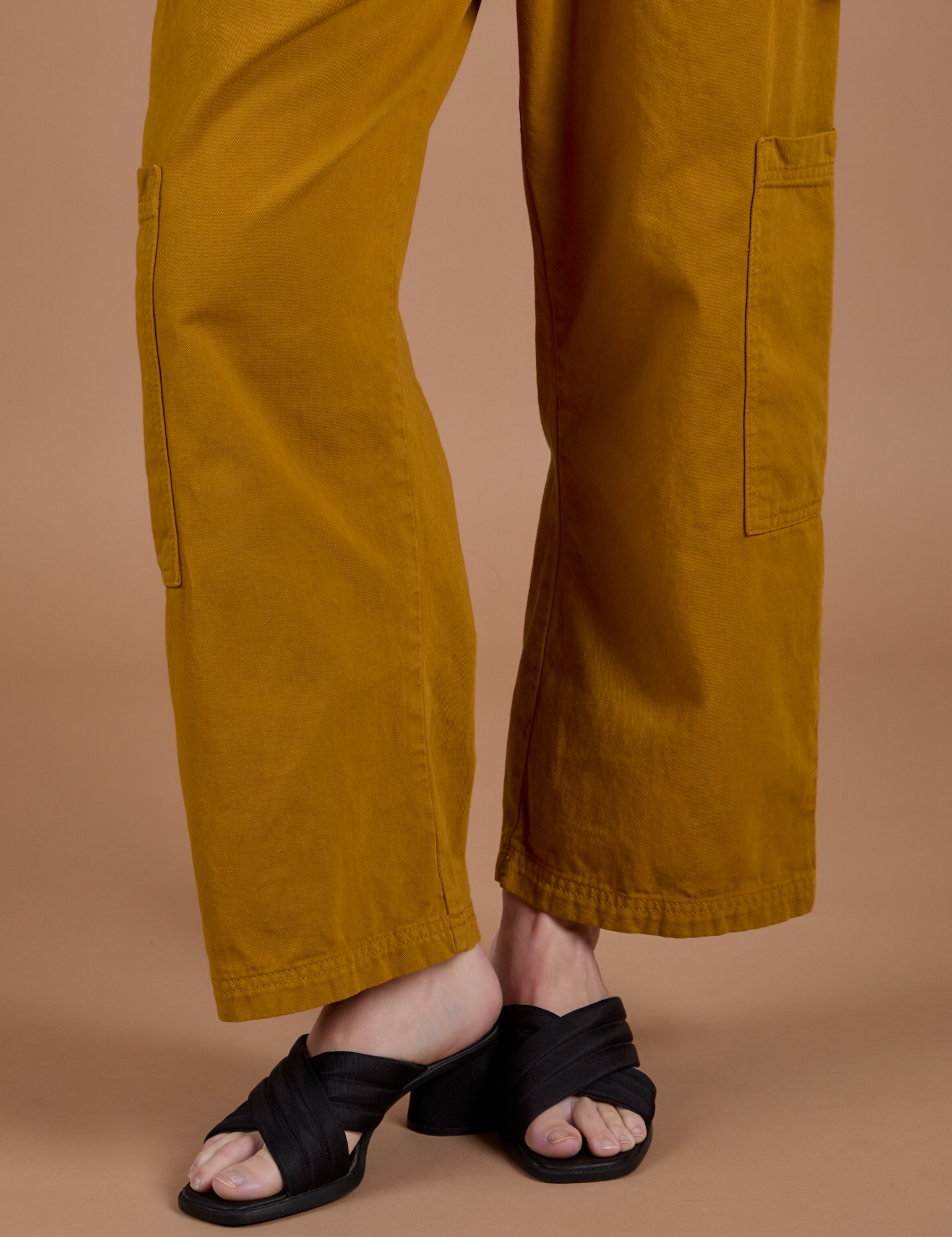 Drop Pocket Cargo Pants in Spicy Mustard pant leg close up on Alex