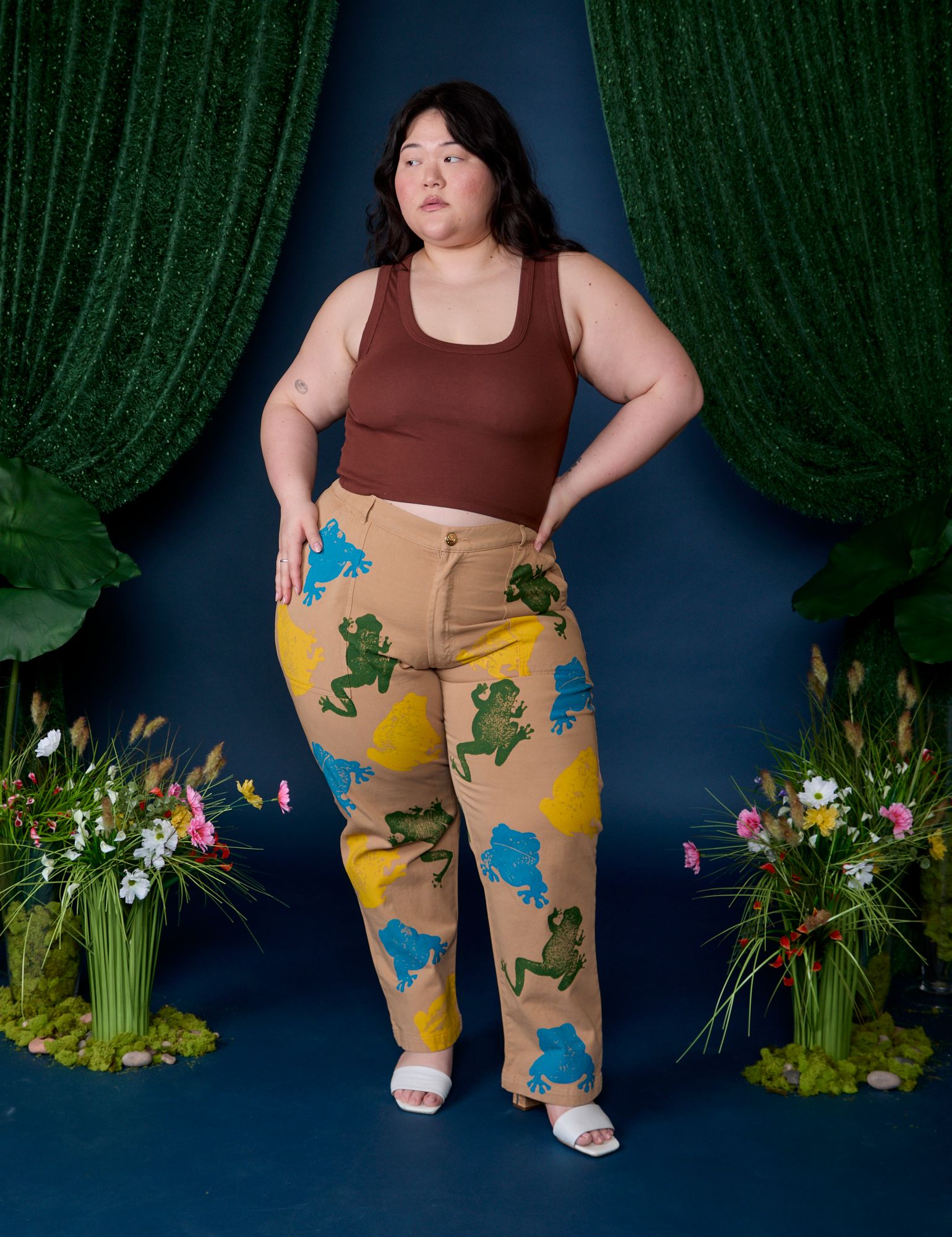 Ashley is wearing Paintstamped Work Pants in Froggy and fudgesicle brown Cropped Tank