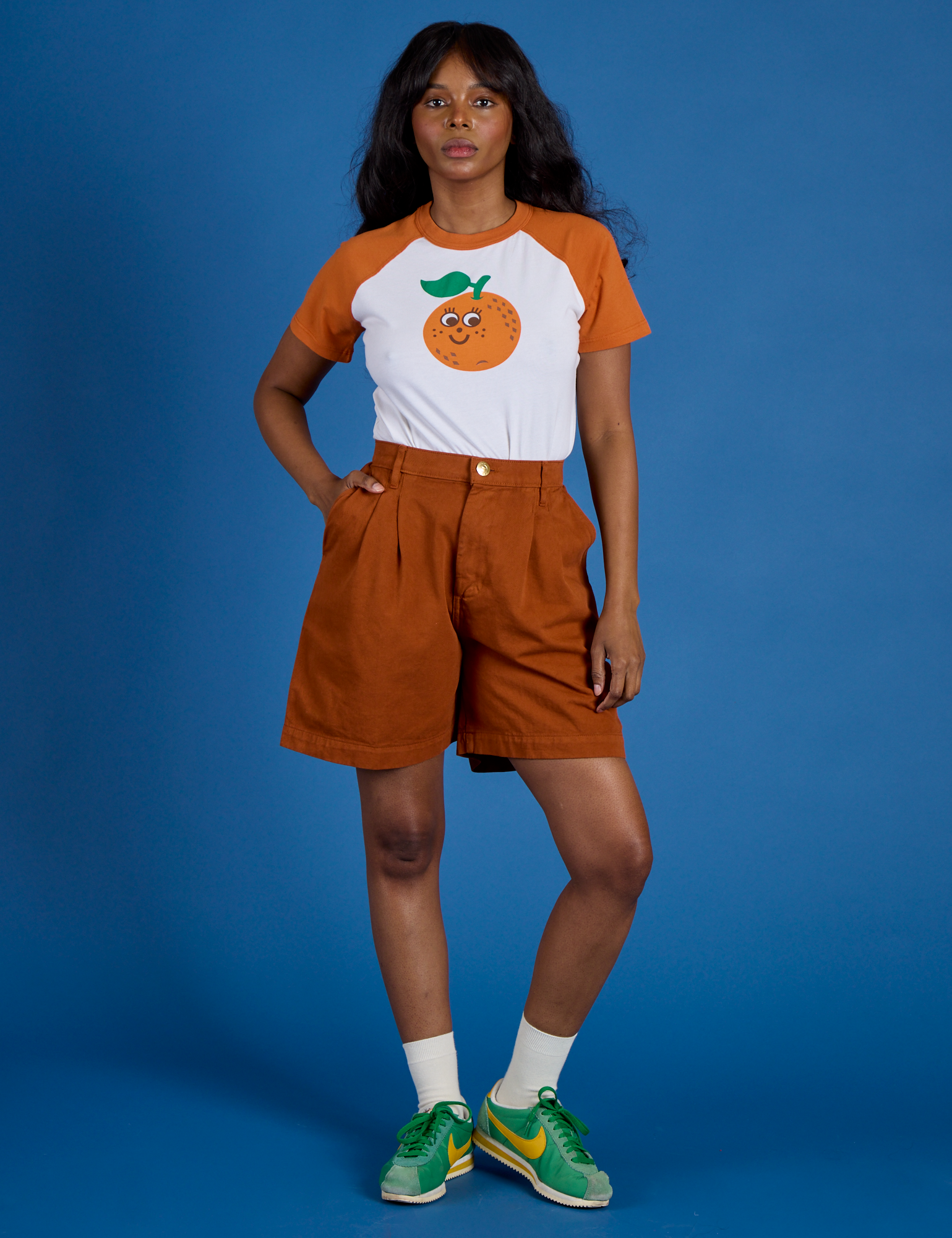 Kandia is wearing Produce Raglan Tee in Orange
