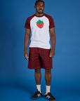 Isaac is wearing Produce Raglan Tee in Strawberry
