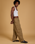 Side view of Baggy Mid-Rise Trousers in Desert Brown and vintage tee-white  Cropped Tank