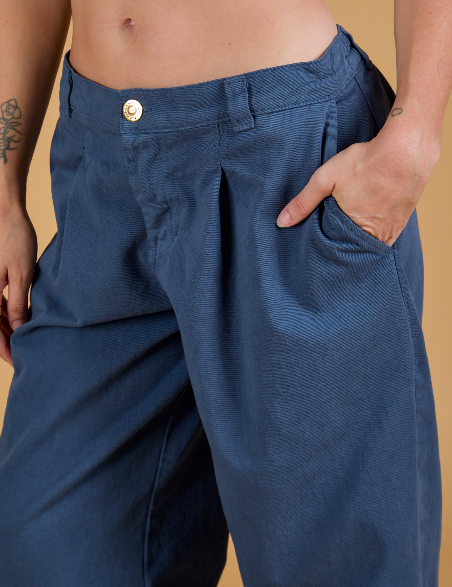Close up of Alex's hand in the front pocket of Baggy Mid-Rise Trousers in French Blue
