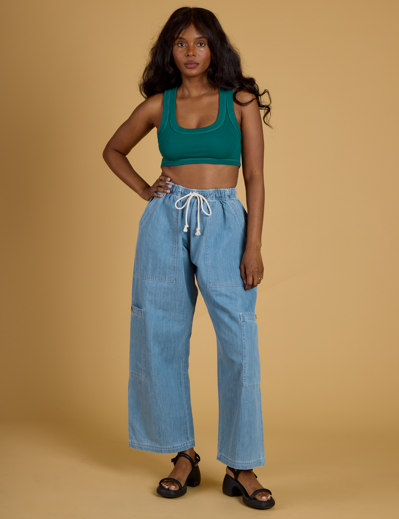 Kandia is wearing Contrast Stitch Mini Tank in Hunter Green and light wash Denim Drop Pocket Pants