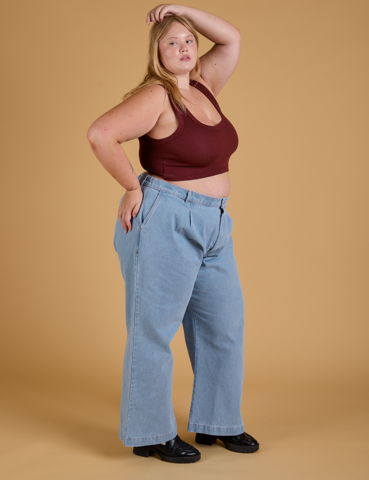 Side view of Mini Tank in Red Wine and light wash Indigo Wide Leg Trousers on Juliet