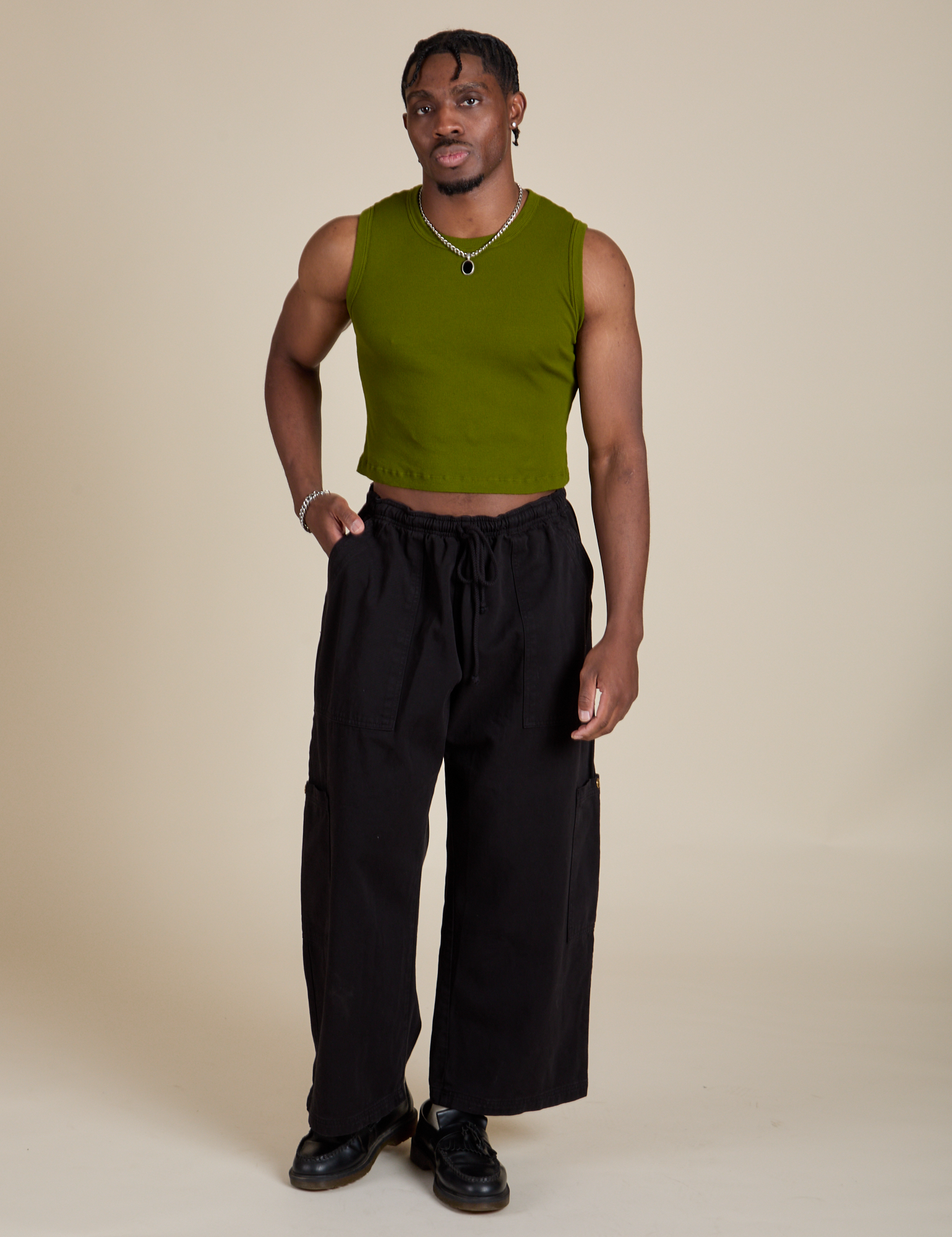 Isaac is wearing Muscle Tee in Summer Olive paired with black Drop Pocket Cargo Pants