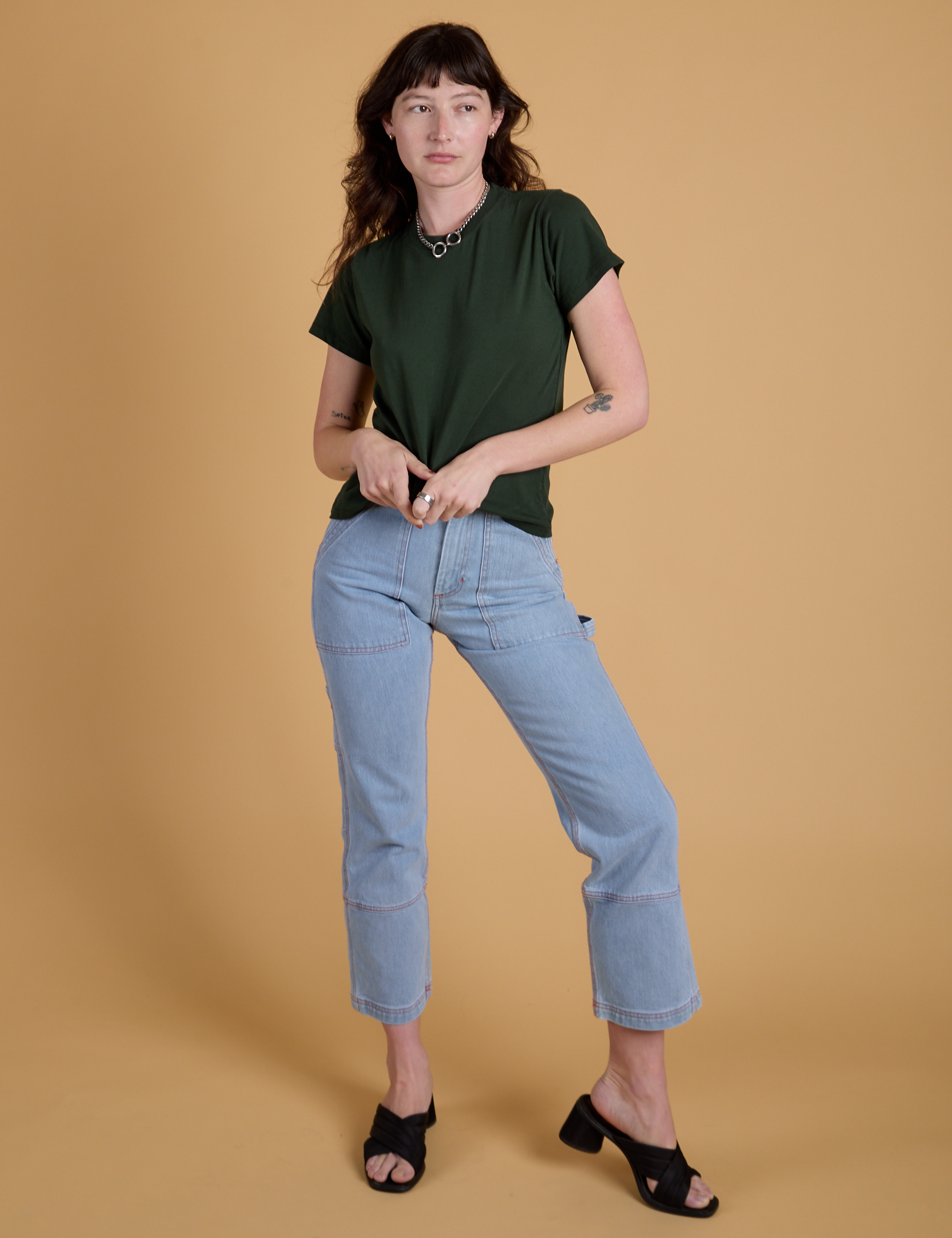 Alex is wearing Organic Vintage Tee in Swamp Green and light wash Carpenter Jeans