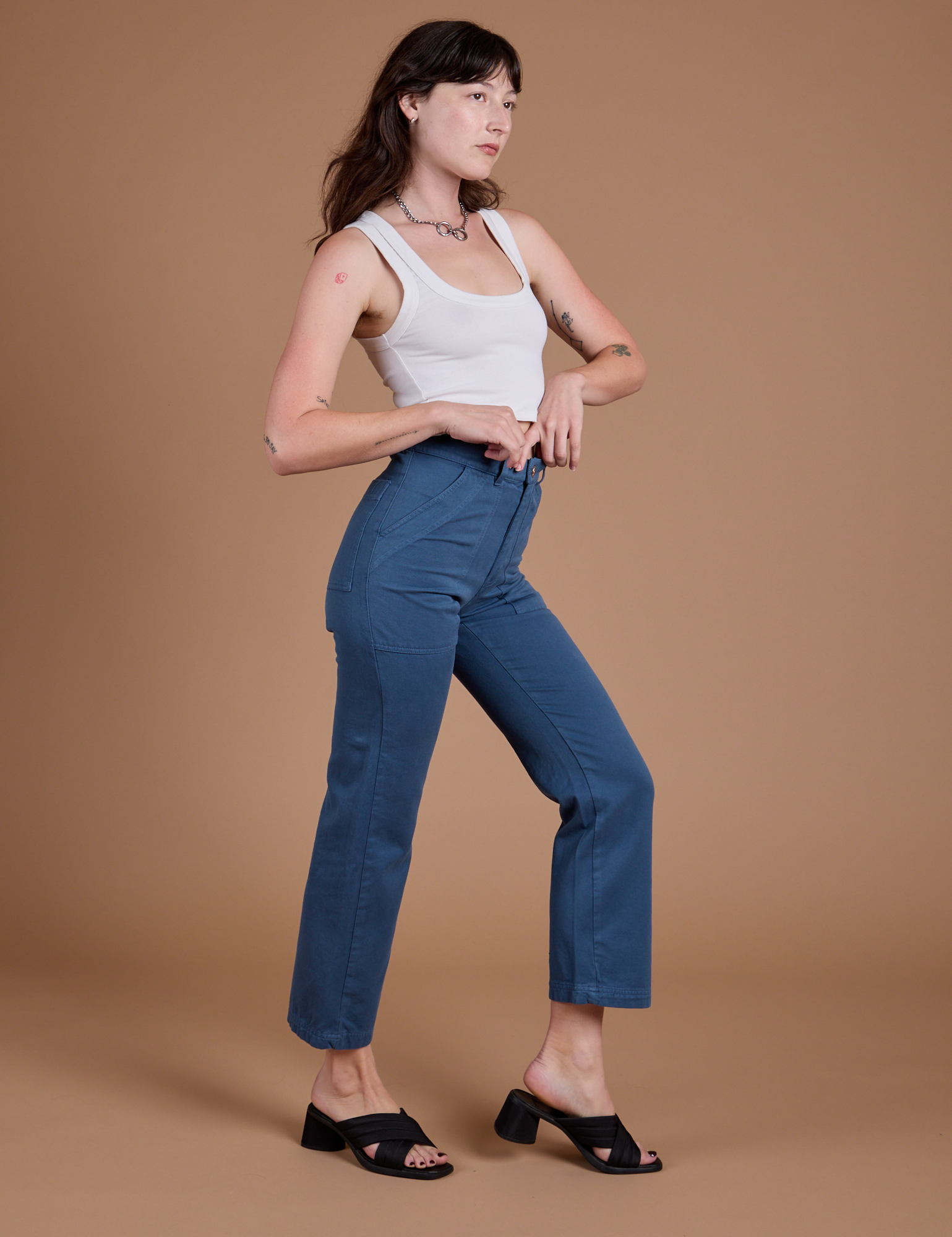 Side view of Organic Work Pants in French Blue and vintage tee white Cropped Tank on Alex