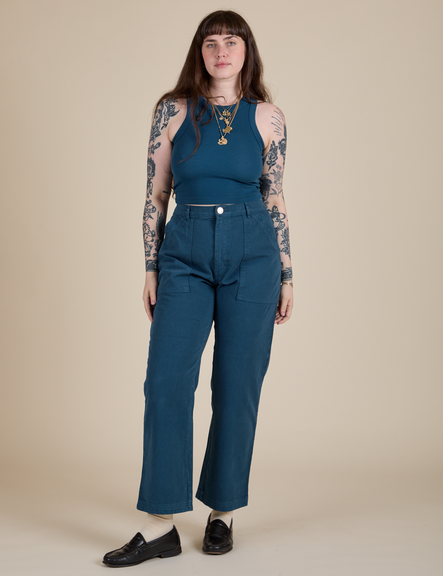 Sydney is wearing Racerback Tank in Lagoon paired with lagoon Work Pants