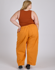 Back view of Drop Pocket Cargo Pants in Creamsicle Orange and burnt terracotta Cropped Tank on Juliet