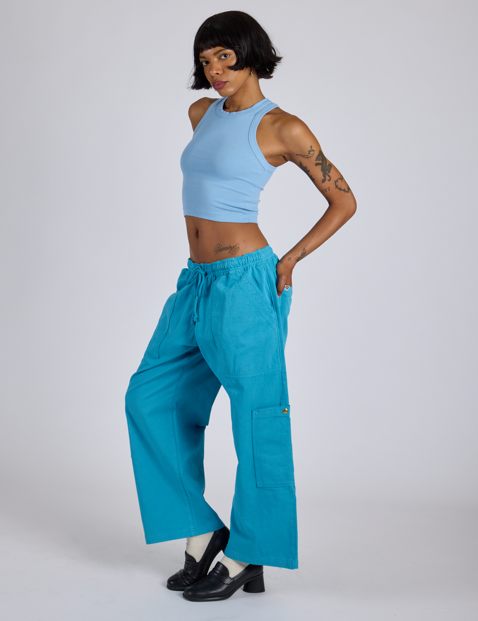 Side view of Drop Pocket Cargo Pants in Hawaiian Blue and baby blue Racerback Tank