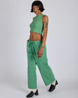 Angled front view of Drop Pocket Cargo Pants in Seafoam Green and matching Muscle Tee on Kira