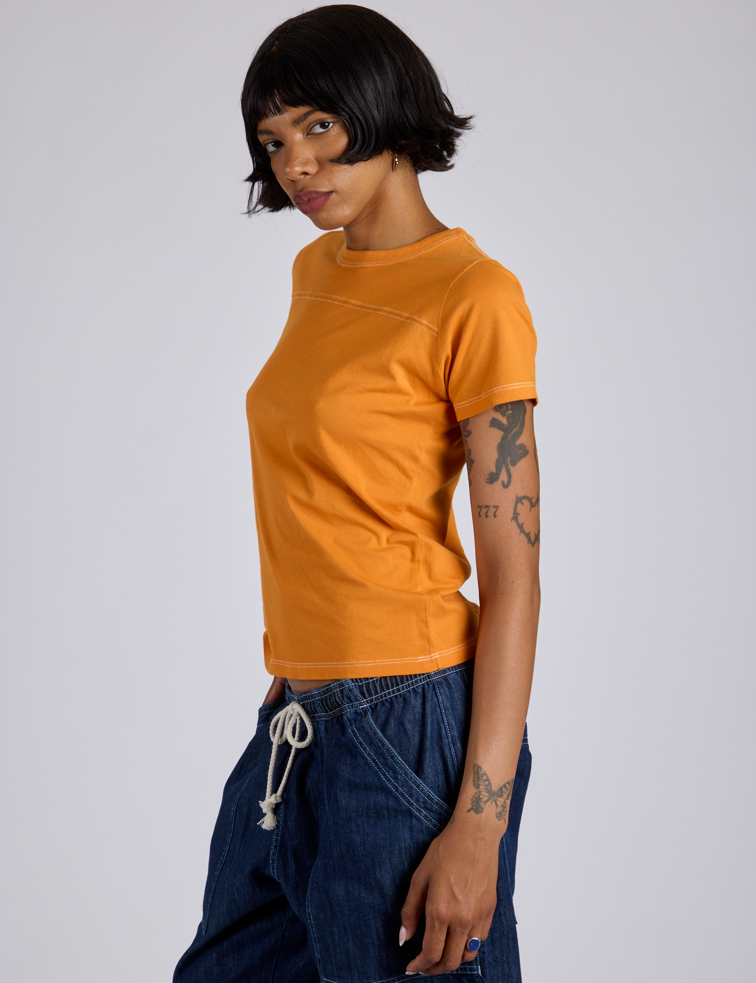 Jr. Varsity Tee in Creamsicle Orange side view on Kira