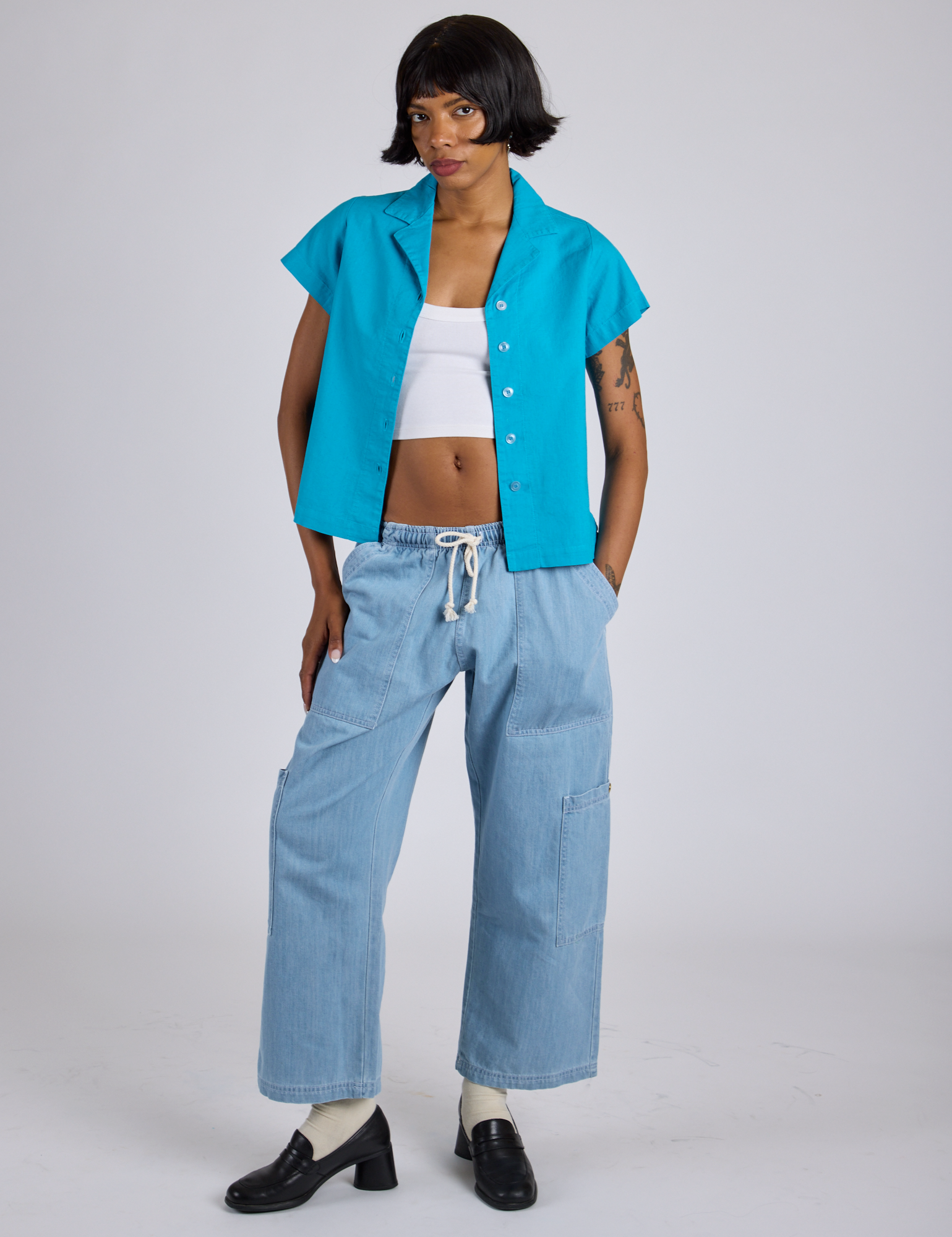 Kira is wearing Pantry Button-Up in Hawaiian Blue and light wash Denim Drop Pocket Pants