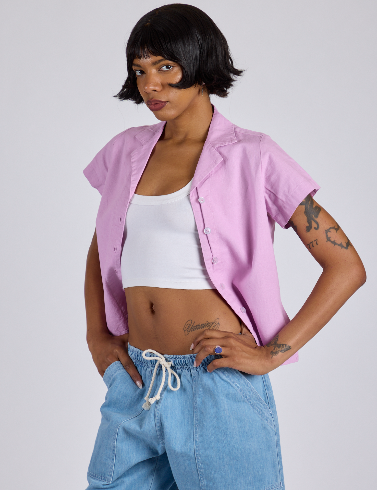 Angled front view of Pantry Button-Up in Lilac Purple with a Cropped Tank in Vintage Tee White underneath