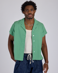 Isaac is wearing Pantry Button-Up in Seafoam Green