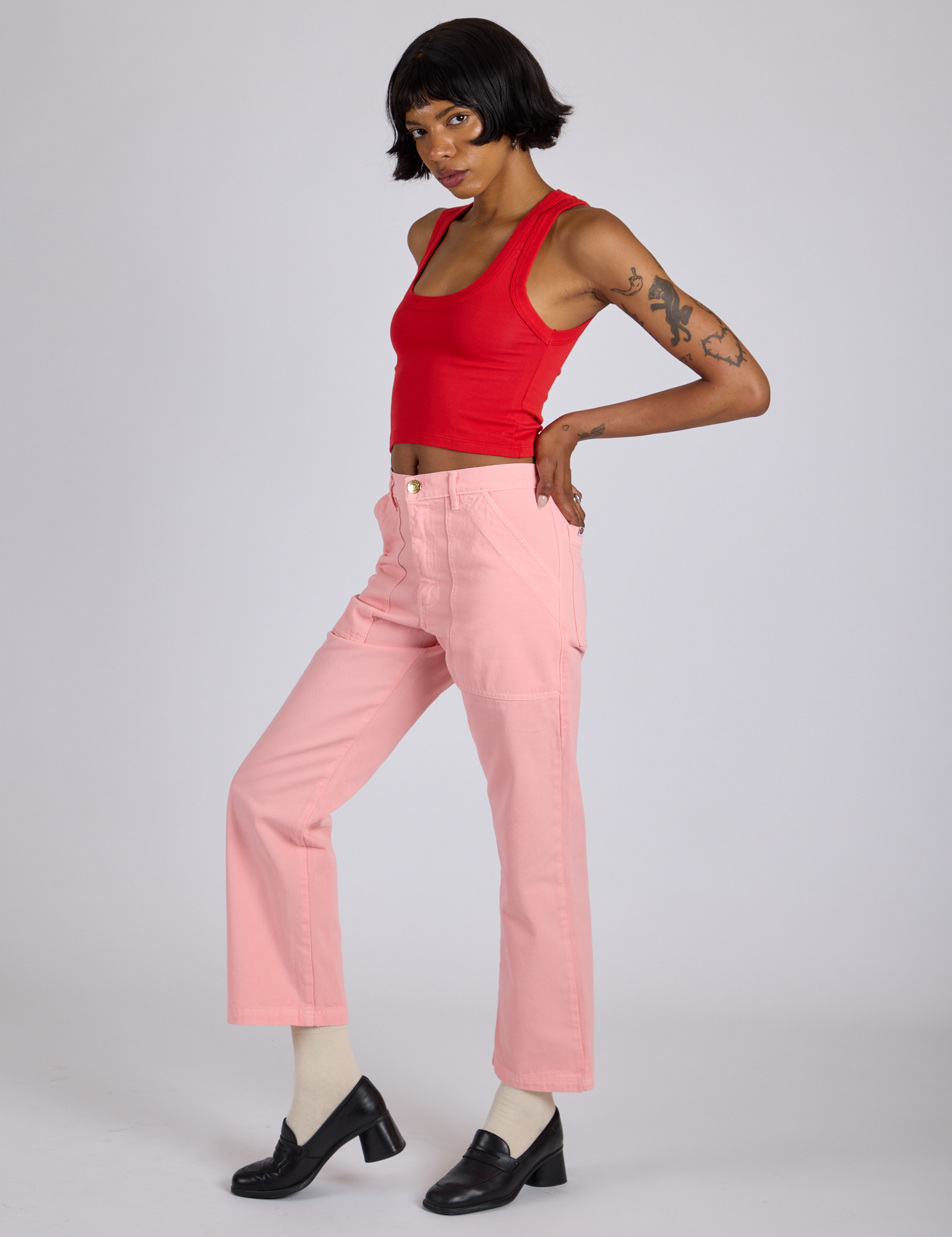 Side view of Work Pants in Baby Pink and mustang red Cropped Tank on Kira