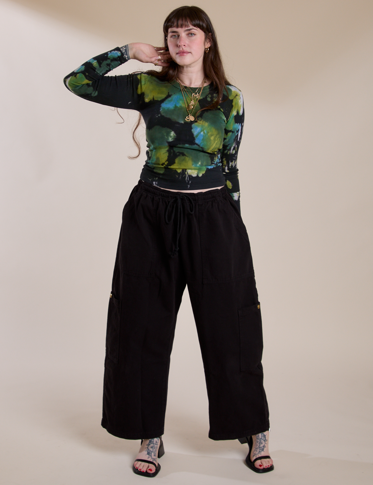 Sydney is wearing Long Sleeve Baby Tee in Green Pool paired with black Drop Pocket Cargo Pants