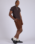 Side view of Pleated Trouser Shorts in Fudgesicle Brown and espresso brown Organic  Vintage Tee