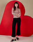 Alex is wearing Long Sleeve Baby Tee in Hot Stuff Print and black Western Pants