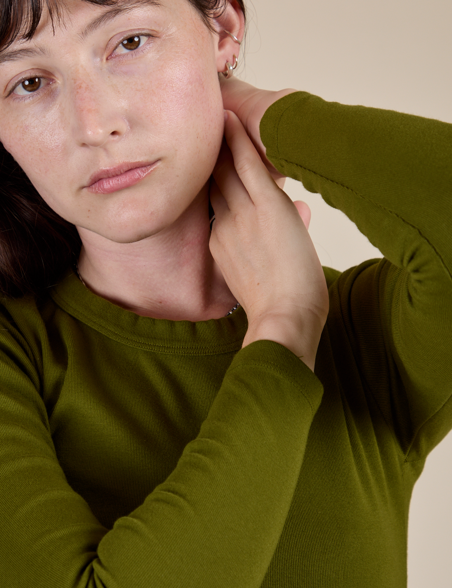 Close up of Long Sleeve Baby Tee in Summer Olive on Alex