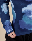 Long Sleeve Baby Tee in Blue Magic Waters bottom close up with Ashley pulling the hem