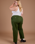 Angled back view of Organic Action Pants in Evergreen and vintage tee Cropped Tank on Juliet