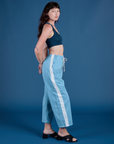 Side view of Painted Drop Pocket Cargo Pants in Baby Blue and lagoon Mini Tank on Alex