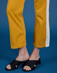 Painted Work Pants in Mustard Yellow pant leg close up on Alex
