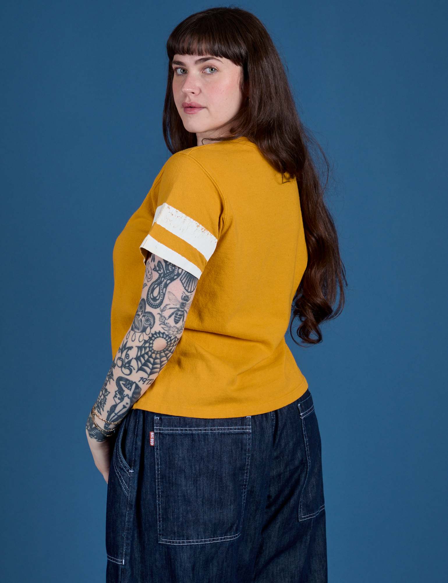 Painted Burly Tee in Mustard Yellow angled back view on Sydney