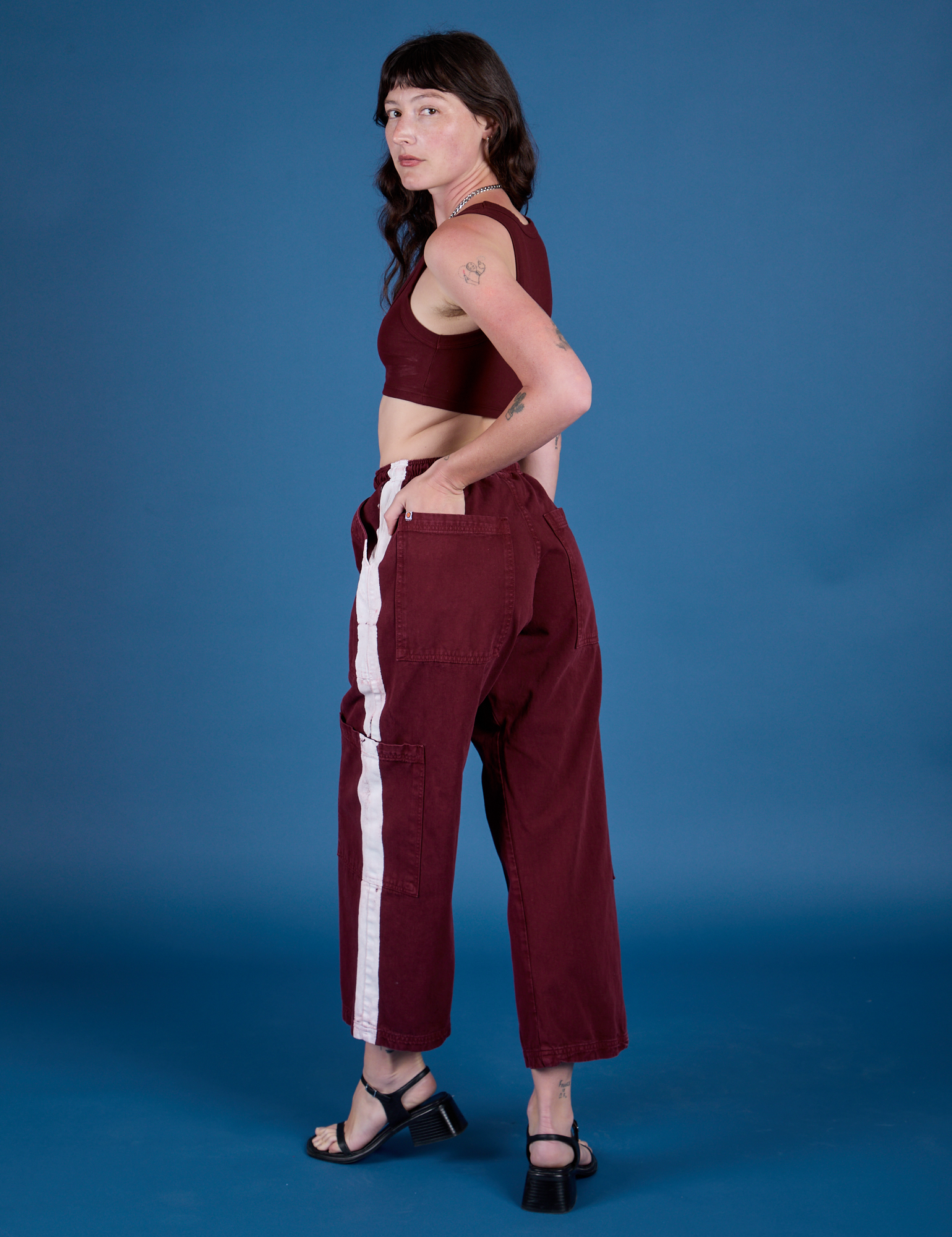 Angled back view of Painted Drop Pocket Cargo Pants in Red Wine on Alex