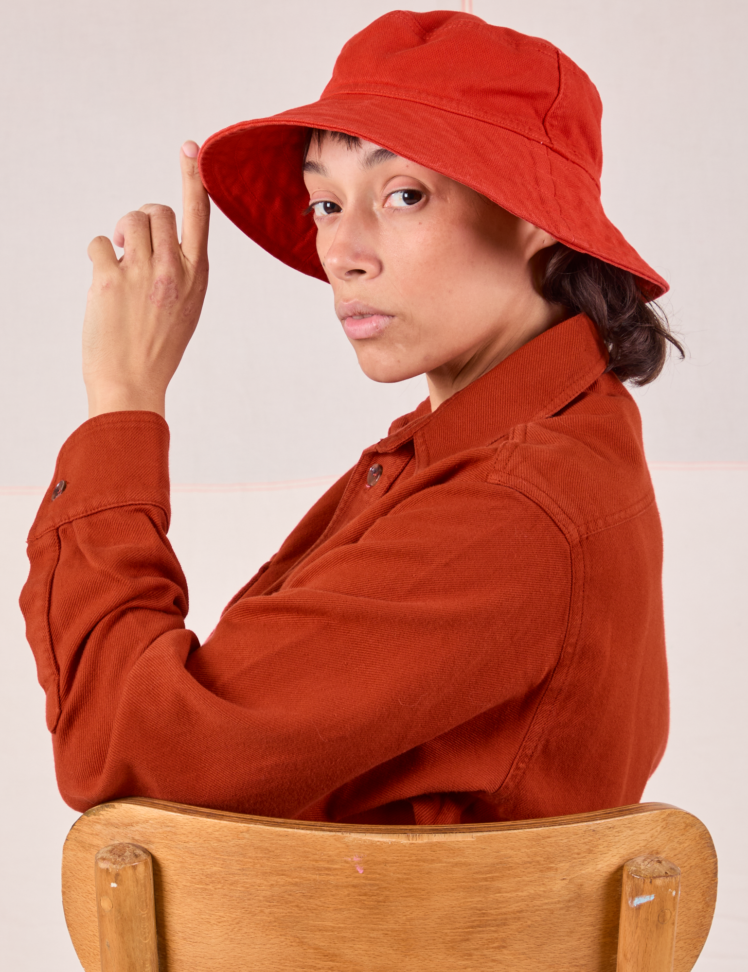 Tiara is wearing the Wide Brim Denim Bucket Hats in Mustang Red